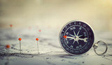 Fototapeta Mapy - Magnetic compass on world map.Travel, geography, navigation, tourism and exploration concept background. Macro photo. Very shallow focus.