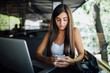 © dianagrytsku - Beautiful brunette woman using laptop in cafe. Blogger work concept