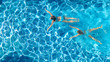 © Iuliia Sokolovska - Aerial top view of girls in swimming pool water from above, active children swim, kids have fun on tropical family vacation, holiday resort concept