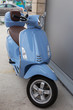 Blue scooter standing on the street
