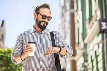 Wall Mural - Waist up of positive man standing outdoors