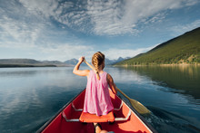 Young Girl Canoeing On A Lake 