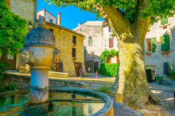 Wall Mural - a narrow street in the old town of Vaison-la-Romaine in France