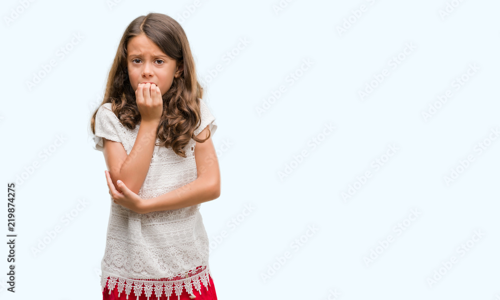 Brunette hispanic girl looking stressed and nervous with hands on mouth biting nails. Anxiety problem.