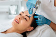© zinkevych - Rejuvenation of skin. Delighted nice woman smiling while enjoying hydrafacial procedure