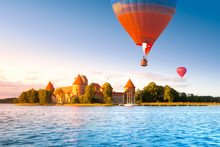 Landscape With Red Brick Castle On Island And Flying Air Balloon In Trakai, Lithuania