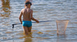 © schankz - A boy is catching a fish net in the pond