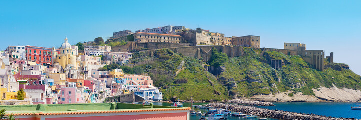 Wall Mural - Panoramic view of of Marina Corricella and Terra Murata in sunny summer day, Procida island, Italy