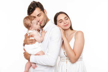 Poster - Portrait of a smiling young family with their little baby girl