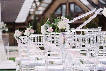 White chairs for guests at a luxury wedding ceremony