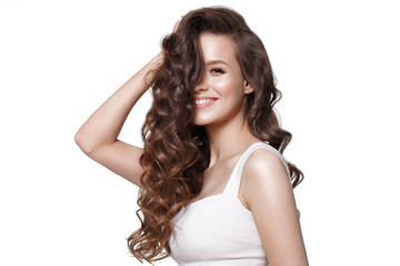 Beautiful young girl in white dress with natural make-up, hair curls and smile. Beauty face.