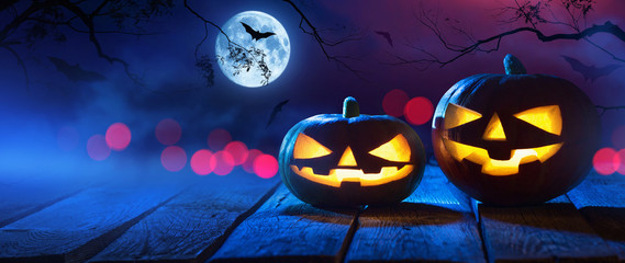 Wall Mural - Halloween Pumpkins On Wood In A Spooky Forest At Night