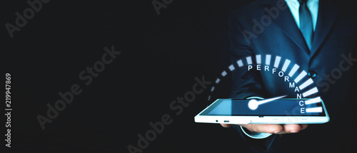 Cuadros en Lienzo Businessman holding Performance speedometer. Business concept