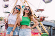 © chichkaua - Closeup portrait happy smiling pretty girls having fun.stylishly dressed in short denim shorts and bright t-shirts, sunglasses.
