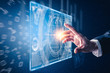 © TimeStopper - The abstract image of the hand point to the business virtual hologram through the computer screen. the concept of communication network, cyber security, internet of things and future life.