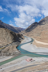 Confluence of the Indus and Zanskar Rivers are two different colors of water ,Zanskar river is shiny blue in colour, Indus river looks a little green in Leh, Ladakh, India