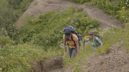 Wall Mural - woman climbing on mountain trail while hiking tour. moutain trip concept