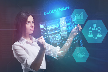 The concept of business, technology, the Internet and the network. A young entrepreneur working on a virtual screen of the future and sees the inscription: blockchain