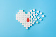 © KaterynaNovikova - a drop of blood on broken heart made of pure white cubes of sugar isolated on blue background, World diabetes day
