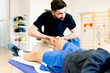 © pagua - massaging knee of athlete patient