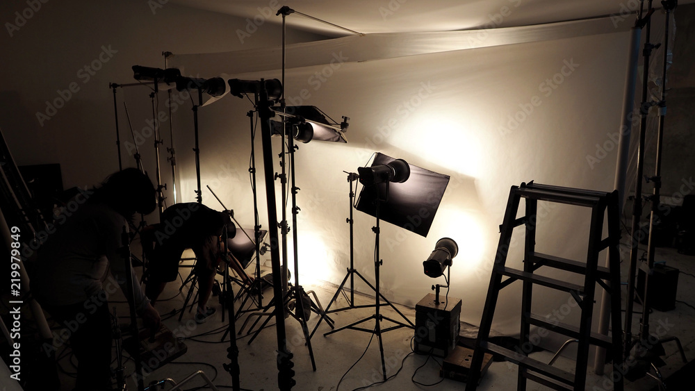 Lighting setup in studio for commercial works such as photo movie or video film production which use many LED light more than 1000 watts with big softbox snoot reflector umbrella and tripods.  - obrazy, fototapety, plakaty 