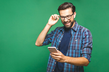always in touch. smiling young man holding smart phone and looking at it. portrait of a happy man us