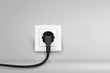 © BillionPhotos.com - White electrical plug in the electric socket on a wall