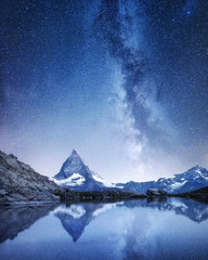 Poster - Matterhorn and reflection on the water surface at the night time. Milky way above Matterhorn, Switzerland. Beautiful natural landscape in the Switzerland