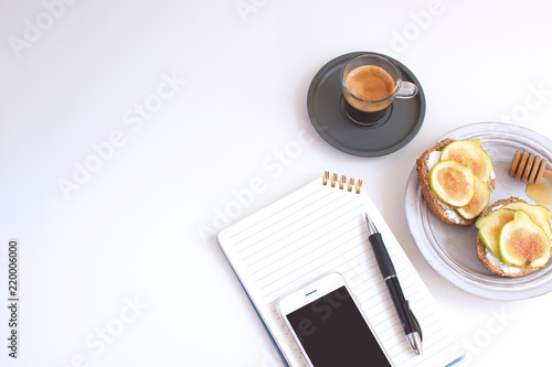 Fotografia, Obraz Worktable Business concept Table Back to school Notepad Cellphone Pen Black coff