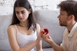 © fizkes - Desperate loving man making marriage proposal to young woman rejecting offer, frustrated girlfriend refuse marry boyfriend, not taking engagement ring, saying no. Relationship breakup concept