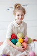 © Olena - The beautiful girl with a smile and with multi-colored skeins of thread