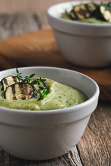 Wall Mural - Healthy zucchini cream soup in ceramic bowls