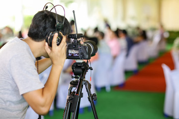 Wall Mural - Photographer and video maker man hold DSLR camera on his hand to making footage. video production artist concept. image for objects, article, copy space and illustration.