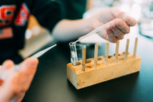 Student Filling Test Tube In Science Laboratory 