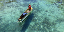 Fisherman In His Boat  On Turquoise Sea