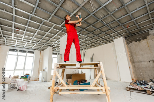 Man In Builder Uniform Installing Suspended Ceiling Buy This