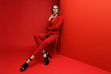 Fashion Young Woman In Red Suit.