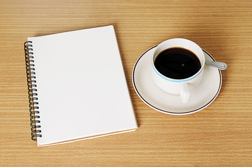 Black Coffee cup with notebook on wood table