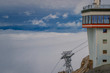 Part of a building and the pylon of the cable car on the summit of Zugspitze on a cloudy summer day