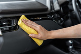 Fototapeta Przestrzenne - hand with microfiber cloth cleaning car console