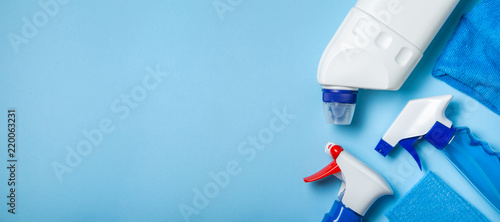 Fotomural Cleaning supplies - bottles, sprays sponge on bright pastel background