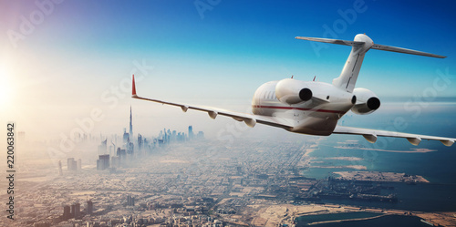 Fotografía Luxury private jetliner flying above Dubai city, UAE.