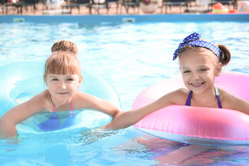 Poster - Cute little girls swimming in pool on summer day