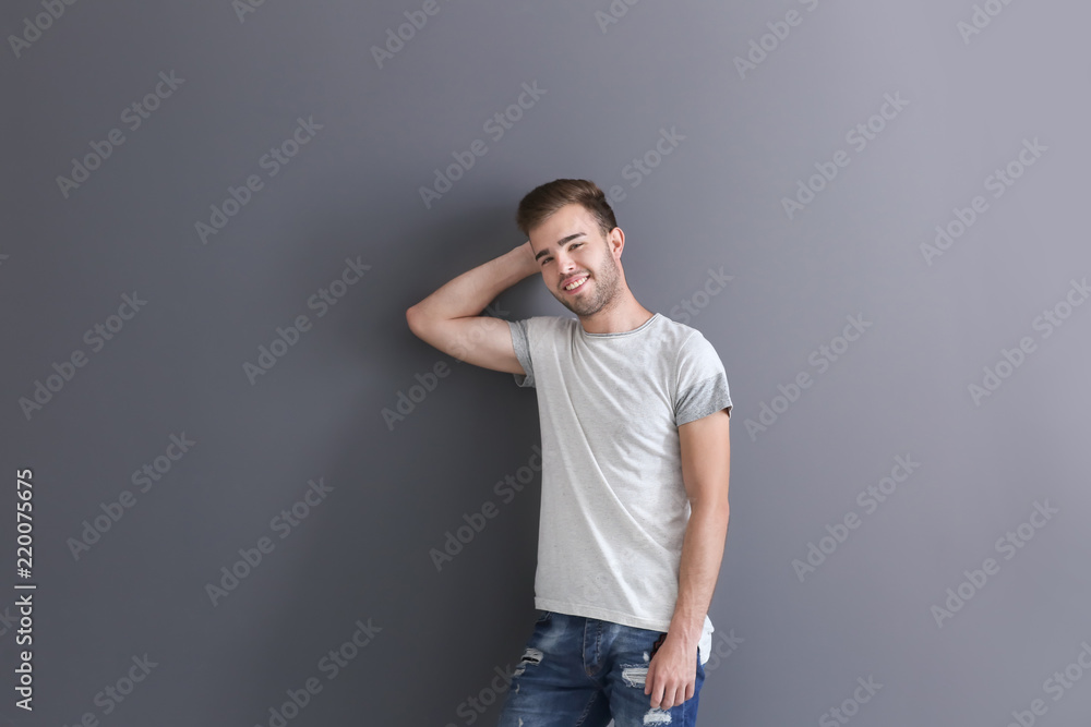 Portrait of handsome young man on grey background
