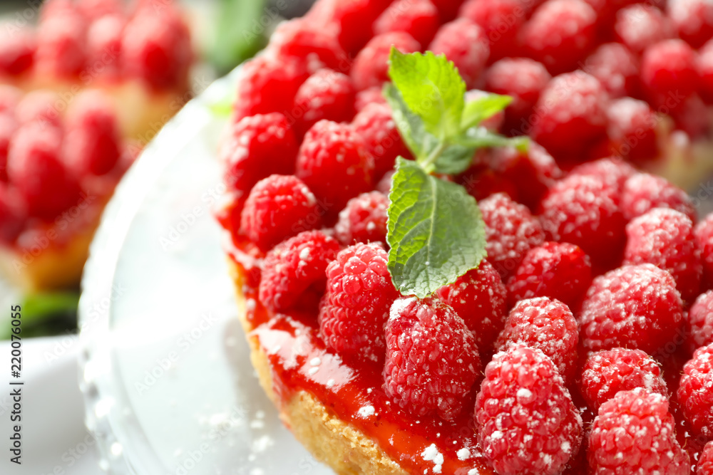 Delicious raspberry cheesecake on dessert stand, closeup