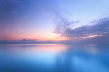 sunrise on the water / early summer morning bright sky beach