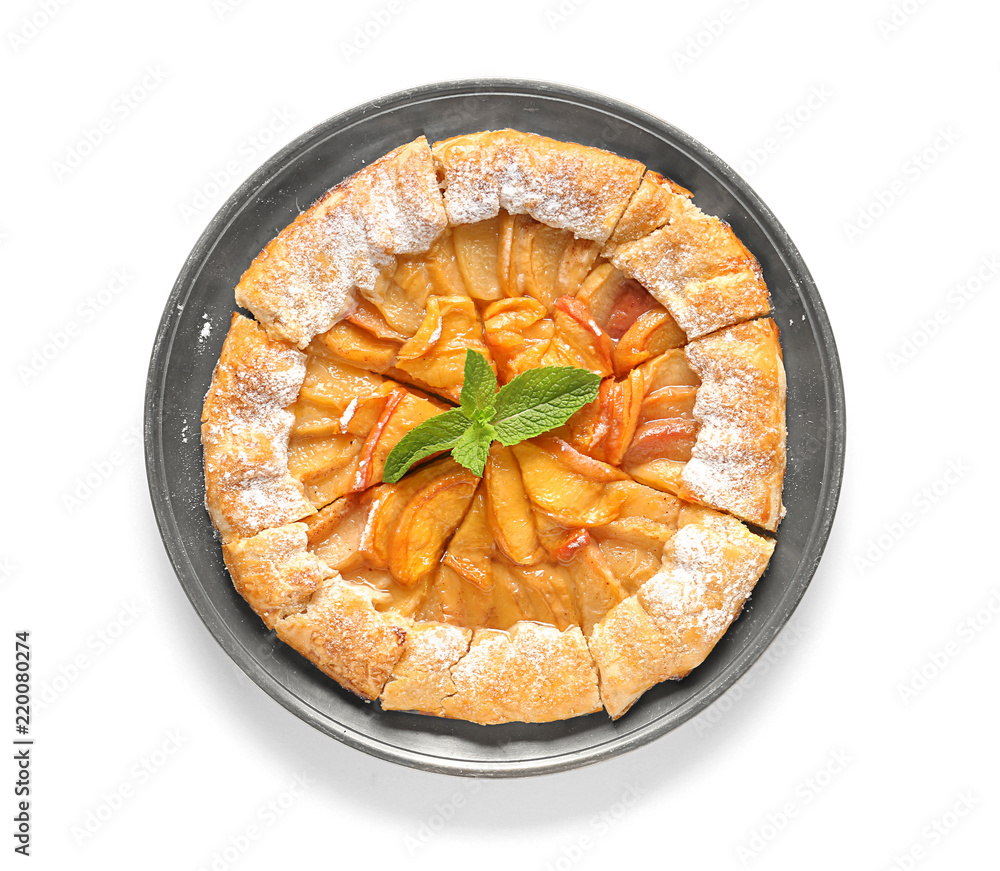 Plate with delicious peach galette on white background