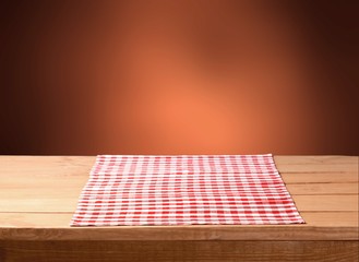 Sticker - Red cloth napkin on wooden background