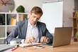 © Pixel-Shot - Handsome businessman working in office