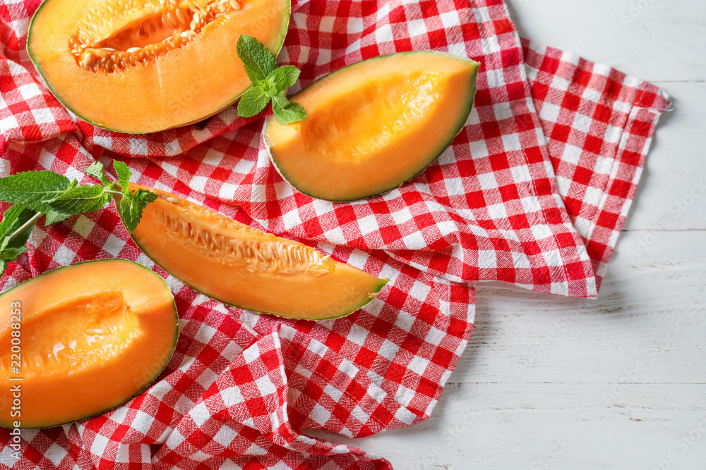 Pieces of tasty ripe melon on table